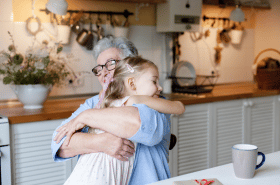 Child giving grandmother a hug
