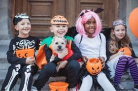 Children following Halloween safety tips while trick-or-treating