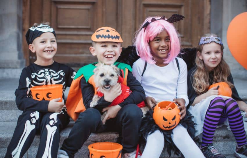 Children following Halloween safety tips while trick-or-treating