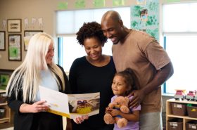 Family choosing a daycare by going on a school tour with the director