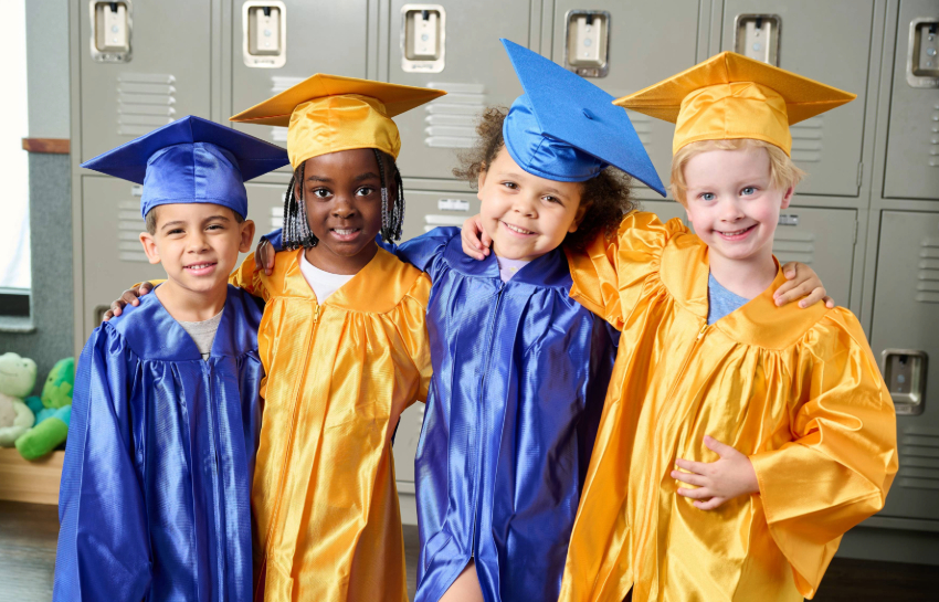 New Horizon Academy pre-kindergarten graduates wearing graduation caps and gowns and getting ready for kindergarten