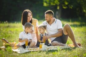 Family enjoying a picnic together outdoors
