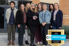 New Horizon Academy marketing team holding 2025 OnCon Icon award for Top 50 best marketing team
