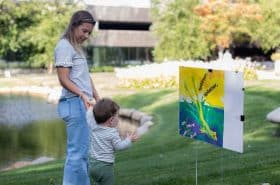 Parent and toddler reading along for New Horizon Academy's story walk event