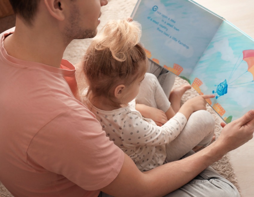 Father reading a book with his toddler child
